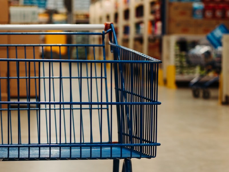 Our location - blue shopping cart on white floor